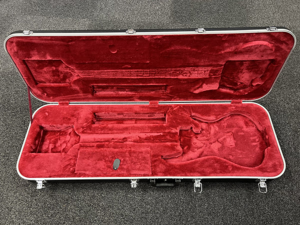 Red guitar case lining on a gray surface