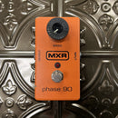 Orange MXR phase 90 effect pedal on a metallic background