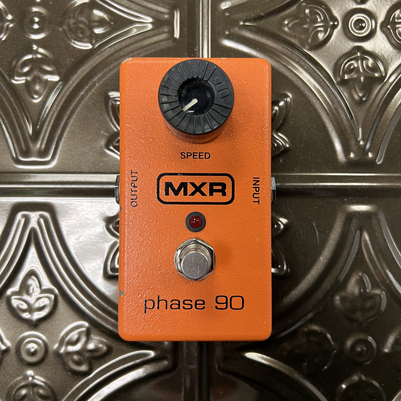 Orange MXR phase 90 effect pedal on a metallic background